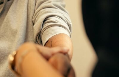 Close-up clinical examination of a patient's arm at Clinique Alpa